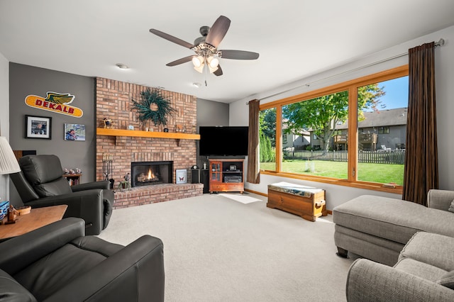 carpeted living room featuring ceiling fan and a fireplace