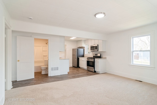 kitchen featuring light hardwood / wood-style floors, white cabinetry, and appliances with stainless steel finishes