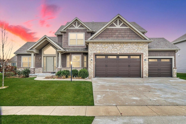 craftsman house featuring a lawn and a garage