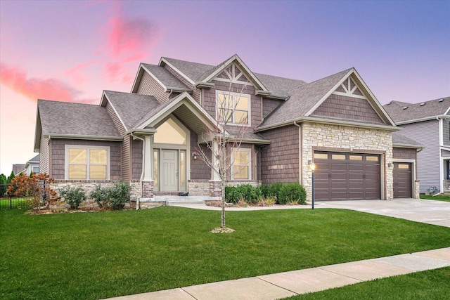 craftsman-style home with a lawn and a garage