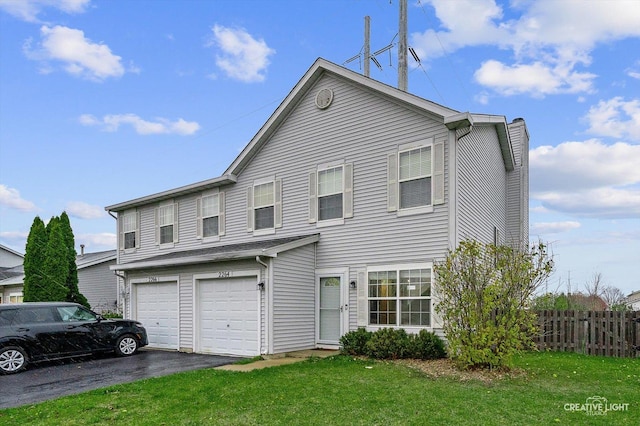 view of front of home with a garage and a front yard