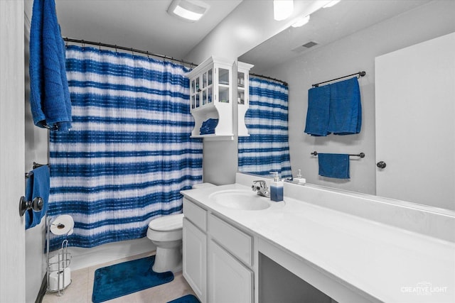 bathroom featuring tile patterned flooring, vanity, curtained shower, and toilet