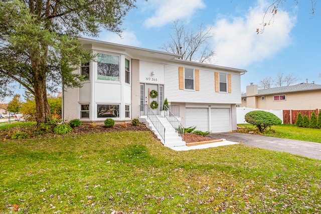 bi-level home featuring a garage and a front lawn