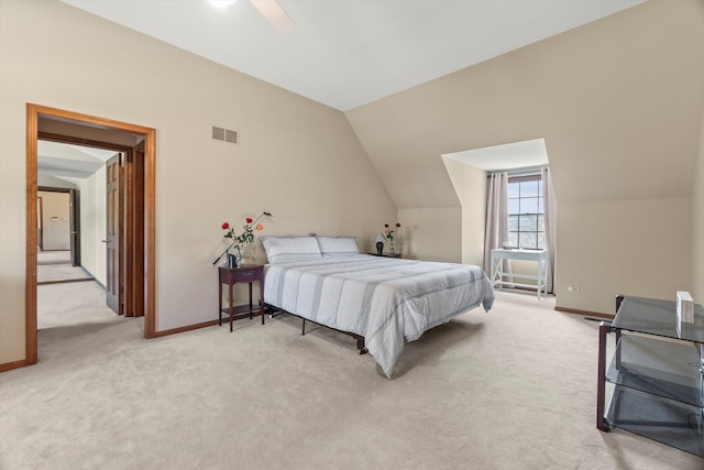 bedroom with ceiling fan, light colored carpet, and lofted ceiling