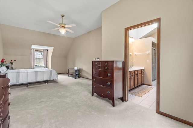 carpeted bedroom featuring ensuite bathroom, ceiling fan, and vaulted ceiling