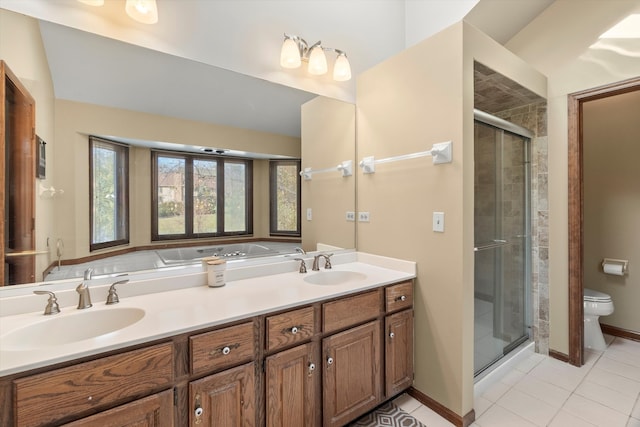 bathroom featuring toilet, vanity, tile patterned floors, and an enclosed shower