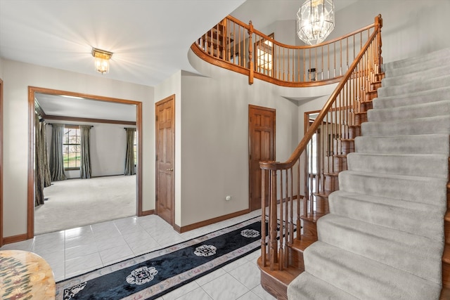 stairs with carpet floors and a chandelier