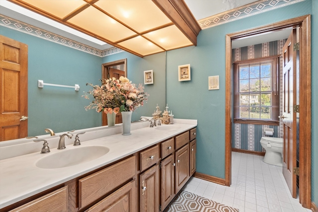 bathroom with tile patterned flooring, vanity, and toilet