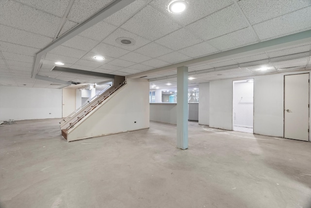 basement with a paneled ceiling