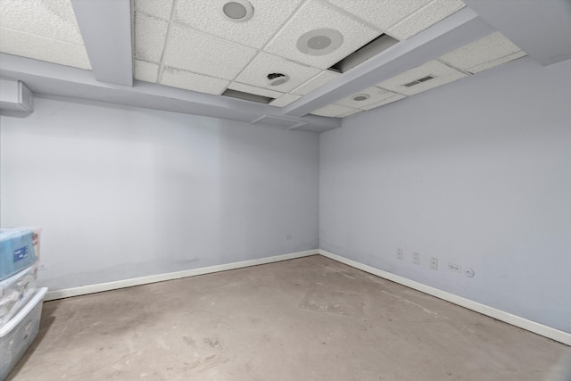 interior space featuring a paneled ceiling and concrete floors