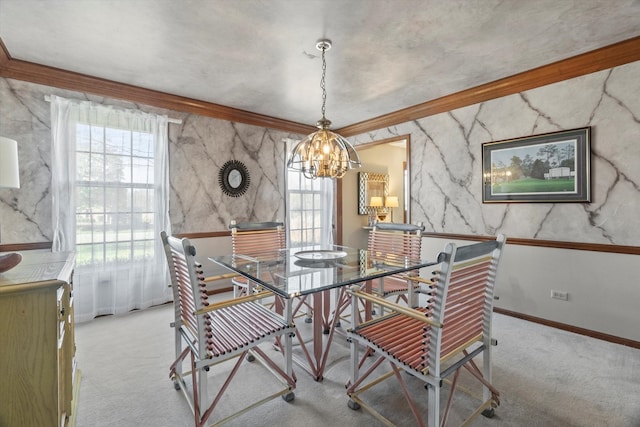 dining room with light colored carpet, ornamental molding, and a notable chandelier