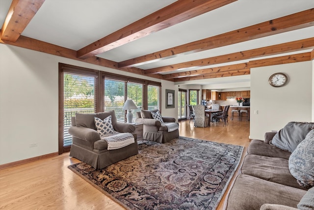 living room featuring light hardwood / wood-style flooring and beamed ceiling