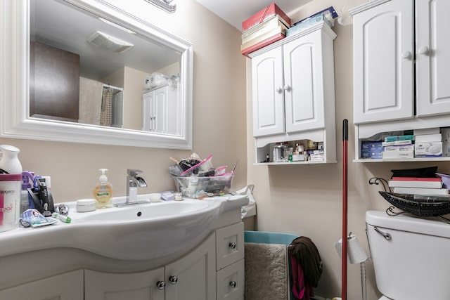 bathroom with vanity and toilet