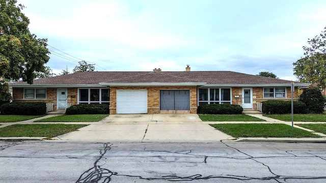 single story home featuring a front yard and a garage