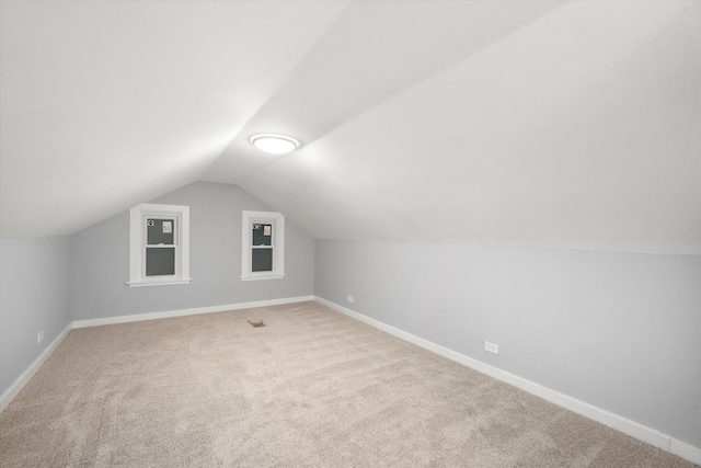 bonus room with carpet flooring and lofted ceiling