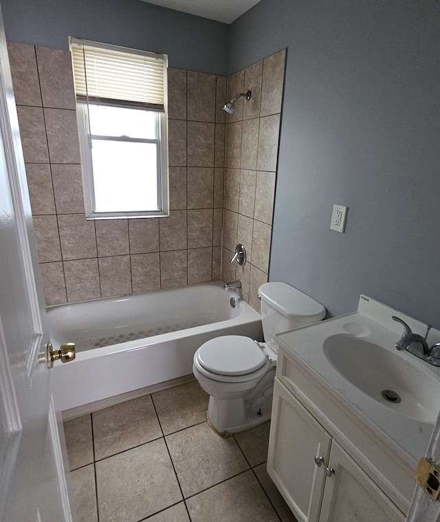 full bathroom featuring vanity, tiled shower / bath combo, tile patterned floors, and toilet