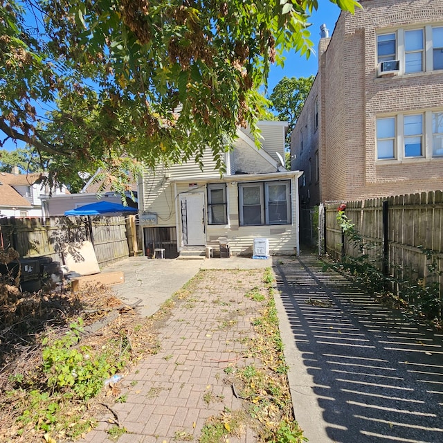 view of front facade with cooling unit and a patio