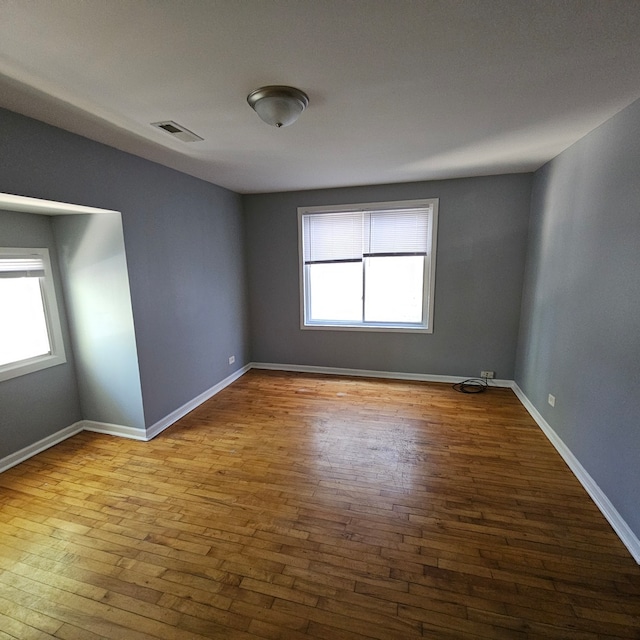 empty room featuring hardwood / wood-style floors and a wealth of natural light