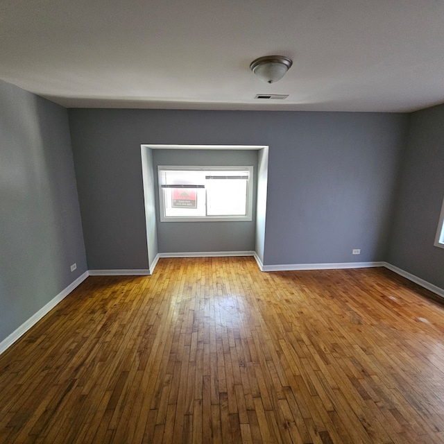 empty room featuring hardwood / wood-style flooring