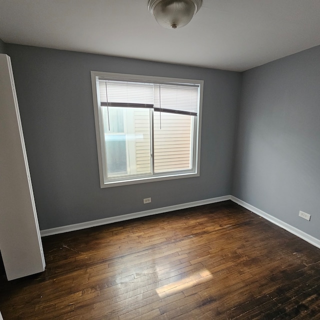 empty room featuring dark wood-type flooring