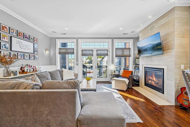 living room featuring hardwood / wood-style flooring and crown molding