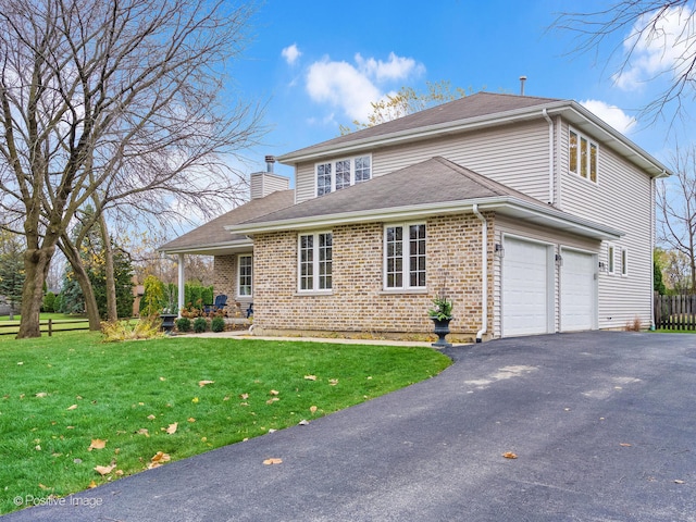 front of property with a front yard and a garage