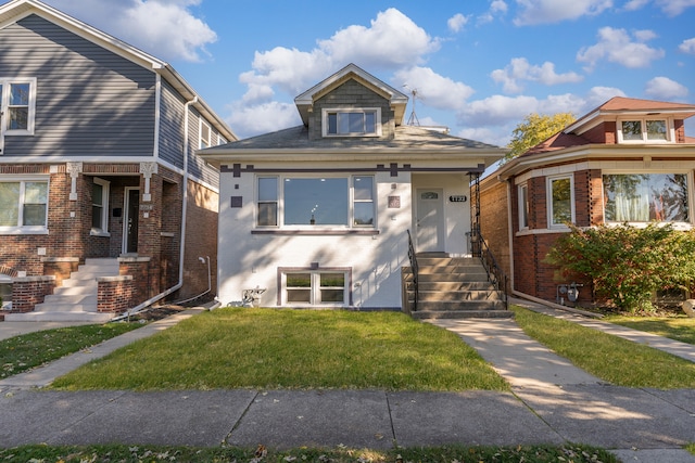 bungalow-style home with a front lawn