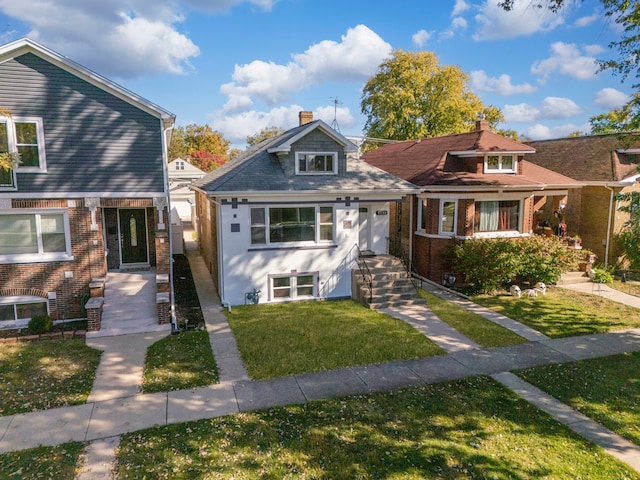 view of front of home featuring a front yard and central AC