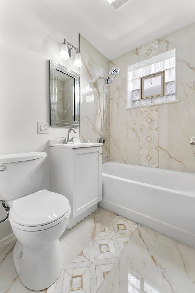 full bathroom with vanity, tiled shower / bath combo, and toilet