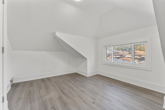 bonus room featuring light hardwood / wood-style floors and lofted ceiling