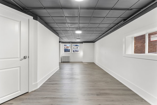 interior space with hardwood / wood-style floors and radiator heating unit