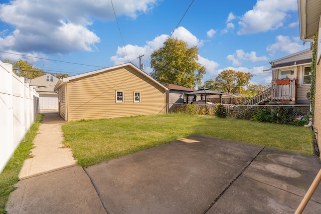 exterior space with a lawn, a patio area, and a gazebo