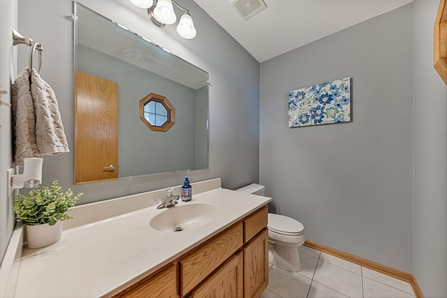 bathroom with tile patterned flooring, vanity, and toilet