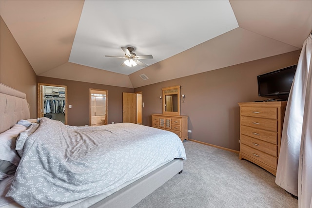 carpeted bedroom featuring vaulted ceiling, a spacious closet, a closet, and ceiling fan