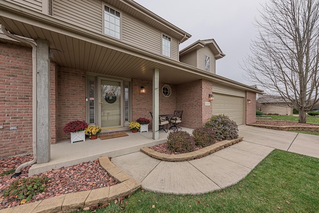 entrance to property with covered porch and a garage