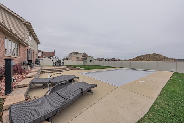 view of swimming pool with a mountain view and a patio