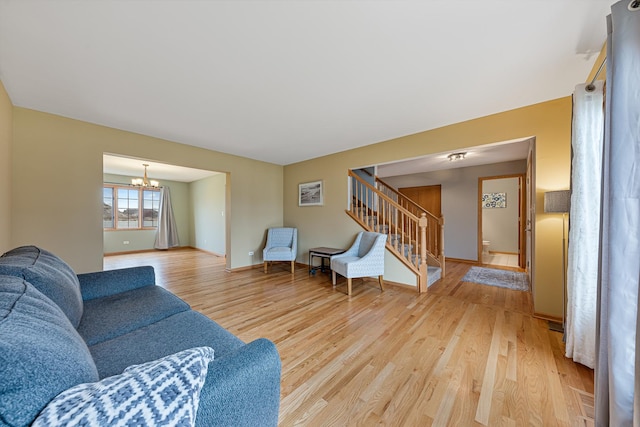 living room featuring hardwood / wood-style floors and a notable chandelier