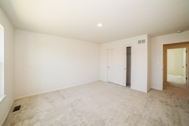 unfurnished room with light colored carpet