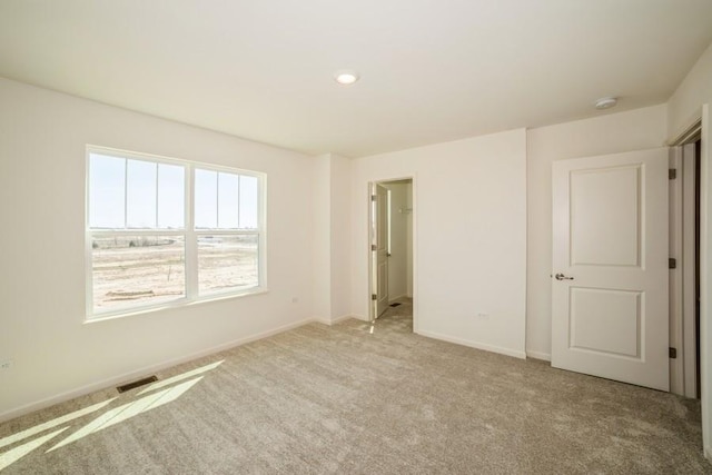 unfurnished room with light carpet