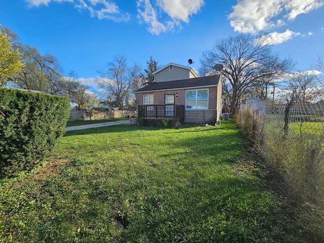 rear view of property with a lawn and a deck