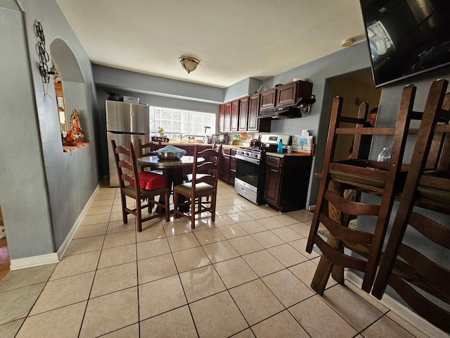 kitchen with light tile patterned floors and stainless steel appliances