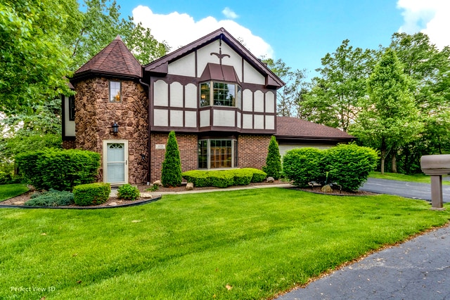 tudor home with a front yard