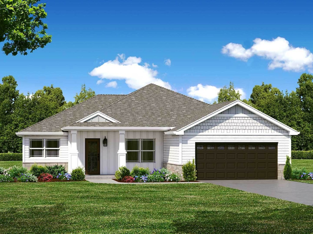 view of front of house featuring a front lawn and a garage