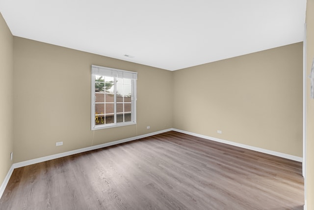 unfurnished room with light wood-type flooring