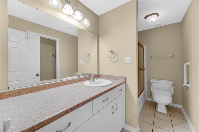 full bathroom featuring tile patterned flooring, vanity, enclosed tub / shower combo, and toilet