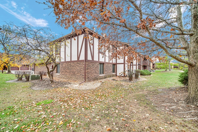 view of side of home featuring a yard