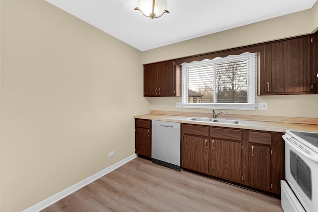 kitchen with light wood-type flooring, white appliances, dark brown cabinetry, and sink