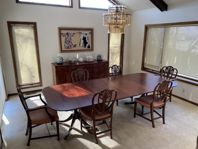 carpeted dining room with a notable chandelier and beam ceiling