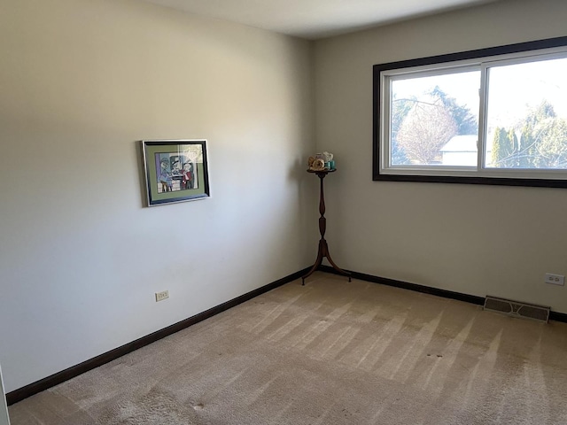 unfurnished room with light colored carpet