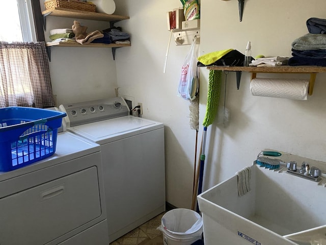 washroom with washer and clothes dryer and sink